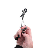 A product shot of the Velvet Noir Tuggable Nipple Clamps on a white background, with a woman's finger through the metal loop, as if pulling on it.