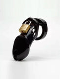 The CB-6000 Male Chastity Device in black is shown against a blank background. The chastity cage is the shape of a flaccid penis and is black and shiny, with a brass padlock on top. There is a rectangular slit at the tip of the cage.