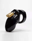 The CB-6000S Male Chastity Device in black is shown against a blank background. The chastity cage is the shape of a flaccid penis and is black and shiny, with a brass padlock on top.