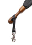 A close up image of the Sissoo Rosewood Short Round Handle Leather Flogger on a white background. Shown is the included leather hanger strap with crab-claw hook attached to the handle of the flogger.