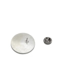 The Stockroom Enamel Pin is shown against a blank background. The pin is circular and has a black background with The Stockroom logo on it and the slogan “Think Kink” underneath.