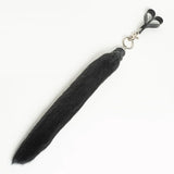 Black faux fur finger flogger on a white background