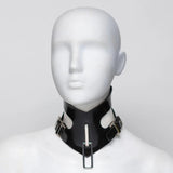 Black rubber posture collar on a mannequin head against a white background. A square ring dangles from the front. 