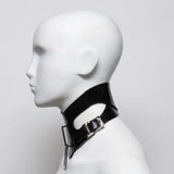 Black rubber posture collar with metal clasp on a mannequin head against a white background
