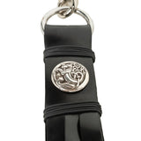 Black rubber strap with silver Celtic knot design on a white background