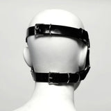 The back view Black rubber head harness on a mannequin head against a white background