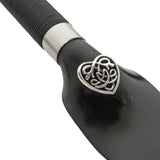 Closeup of the metal insignia on the Dragon Tongue whip. It's a small, metal valentine filled with Celtic knotwork.