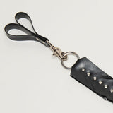 Black rubber finger loops with feathered design and metal accents on a light gray background