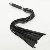 Full view of a black flogger with rubber falls. The handle has a silver base and is wrapped in thin black rubber cord. 