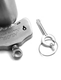 A close-up of the key and key hold for the Houdini Chastity Device is shown on a white background