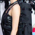 A person shown from the neck down, carrying the KinkBag slung over their shoulder. 