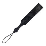 Product shot on a white background. The Velvet Noir Paddle is a loop of vegan faux-leather with a marbled pattern on it.