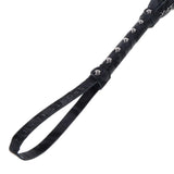 Closeup of the handle of the Velvet Noir Chain Flogger, focused on the wrist strap and the metal studs along the handle. 