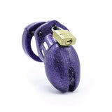 A chastity cage made of purple plastic with glitter embedded in the surface.  A brass padlock on the top keeps it closed.