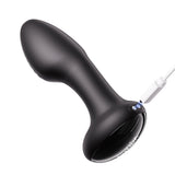 Black model of the Frenzy Butt Plug tilted away from the viewer to show the two charging holes. A white cord comes from the right side, with illustrated electrical current connecting it to the charger. 