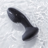 Black model of the Frenzy pressure sensitive butt plug floating in water. 
