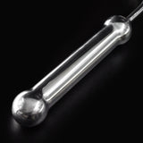 Closeup of the Steer Hook's handle, seen against a black background. The top and bottom of the handle end in a metal ball. 