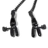 Closeup of the jaws of the nipple clamps, showing the rubber grips and the adjustment screw. 