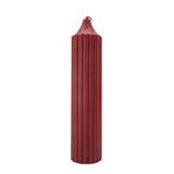 The red scented was play drip candle is shown against a white background. 