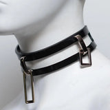 Closeup of a mannequin neck wearing a collar made of two parallel strips of rubber, connected by metal loops.