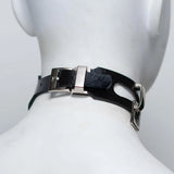 A mannequin wearing a rubber collar, seen from behind to display the closing buckle. 