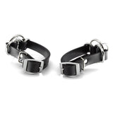 Two rubber wrist cuffs on a white background. The cuffs are viewed from the underside, to show the adjustable buckles. 