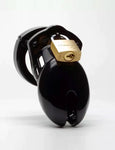 The CB-6000S Male Chastity Device in black is shown against a blank background. The chastity cage is the shape of a flaccid penis and is black and shiny, with a brass padlock on top.