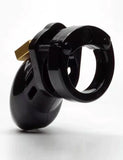 The CB-6000S Male Chastity Device in black is shown against a blank background. The chastity cage is the shape of a flaccid penis and is black and shiny, with a brass padlock on top.